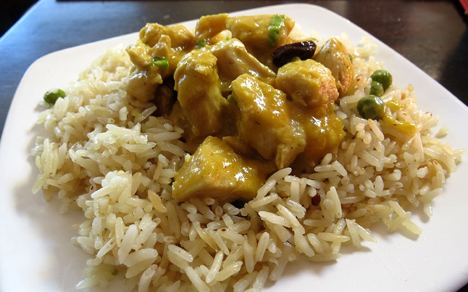 Curry de pollo con mango servido sobre arroz